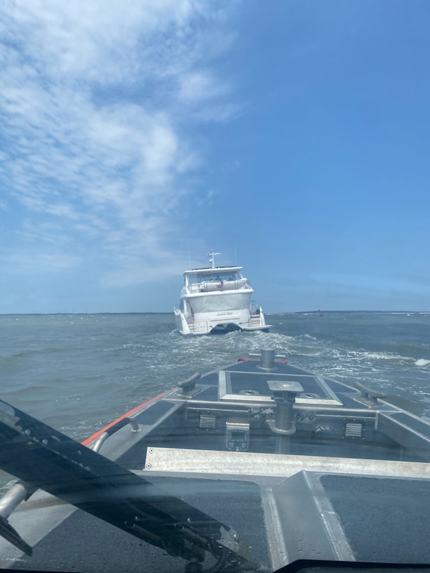 A Coast Guard Station Georgetown boat crew escorts a 52-foot catamaran vessel after it struck the Winyah Bay northern jetty and began taking on water near Georgetown, South Carolina, Aug. 23, 2023.