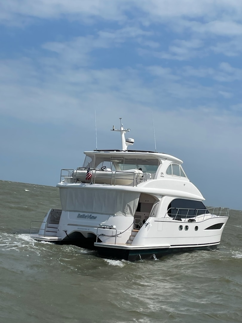 A Coast Guard Station Georgetown boat crew escorts a 52-foot catamaran vessel after it struck the Winyah Bay northern jetty and began taking on water near Georgetown, South Carolina, Aug. 23, 2023.