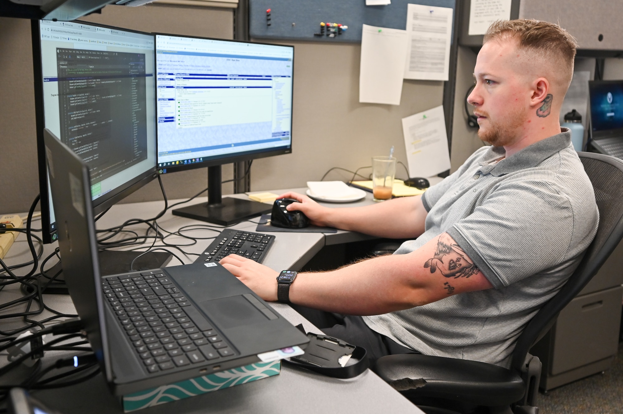 An Air Force civilian working at a computer workstation