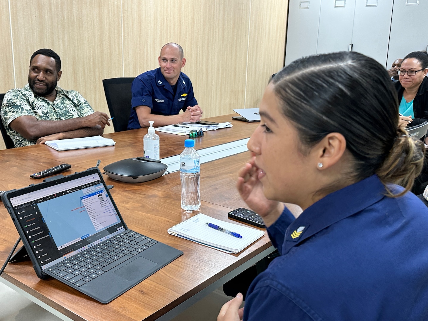 Petty Officer 1st Class Monse Rivera of U.S. Coast Guard 14th District gives partners at the Customs Services an overview of maritime domain awareness tools during a subject matter exchange in Port Moresby, Papua New Guinea, on 18, Aug. 2023. The U.S. Coast Guard is in Papua New Guinea at the invitation of the PNG government to join their lead in maritime operations to combat illegal fishing and safeguard maritime resources following the recent signing and ratification of the bilateral agreement between the United States and Papua New Guinea. (U.S. Coast Guard photo by Chief Warrant Officer Sara Muir)