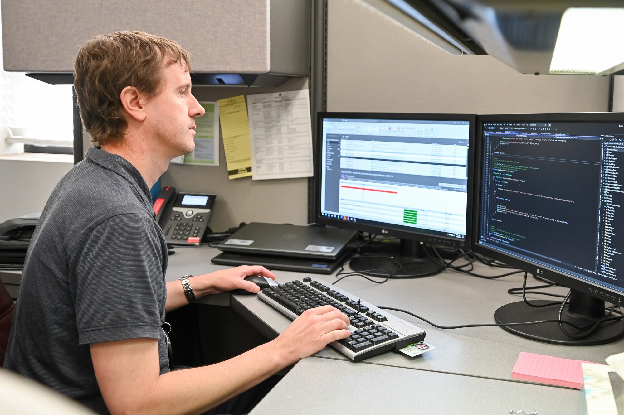 An Air Force civilian worker at a computer workstation