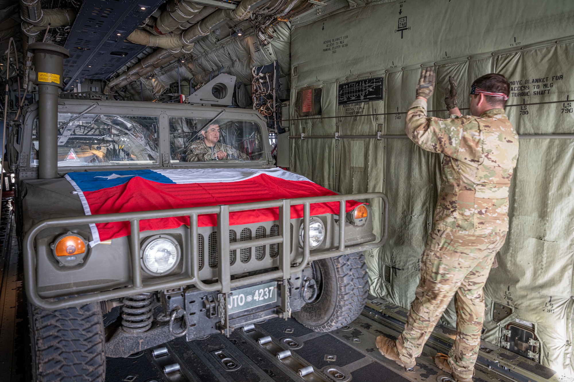 A Chilean Armed Forces Humvee is loaded onto a C-130J Super Hercules from the 39th Airlift Squadron out of the 317th Airlift Wing, Dyess AFB, TX on a runway at the Santiago de Chile Airport, Santiago, Chile, July 28, 2023, during exercise Southern Star 23. Exercise Southern Star 23 is a Chilean-led full-scale Special Operations, Joint, and Combined Employment Exercise. The training consists of staff planning, tactical maneuvers, and collaboration among SOUTHCOM components’ staff, Chilean Armed Forces, and interagency partners during a stabilization scenario which facilitates the opportunity for participants to execute and assess the staff’s ability to plan, coordinate and execute command and control, logistical support, and decision-making processes in a crisis scenario. (U.S. Air Force photo by Staff Sgt. Clayton Wear)