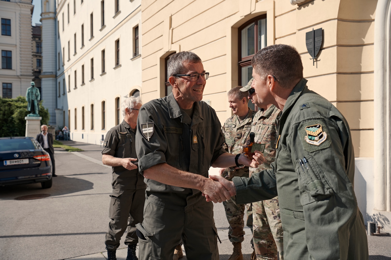 Photo of Commandant of the Austrian Defense Academy Lt. Gen. Erich Csitkovits being gifted Vermont maple syrup as a symbol of friendship by Air Component Commander of the Vermont National Guard, Brig. Gen. Henry Harder, after holding a meeting at the Austrian Defense Academy to discuss cooperation between the Austrian Armed Forces and the Vermont National Guard, Vienna, Austria, June 15, 2023.