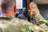 Photo of the newest member of the 158th Fighter Wing, Airman Libass Mbengue, being sworn into the Vermont Air National Guard by Maj. Gen. Gregory Knight, the Adjutant General of the Vermont National Guard, Vermont Air National Guard Base, South Burlington, Vermont May 18, 2023.