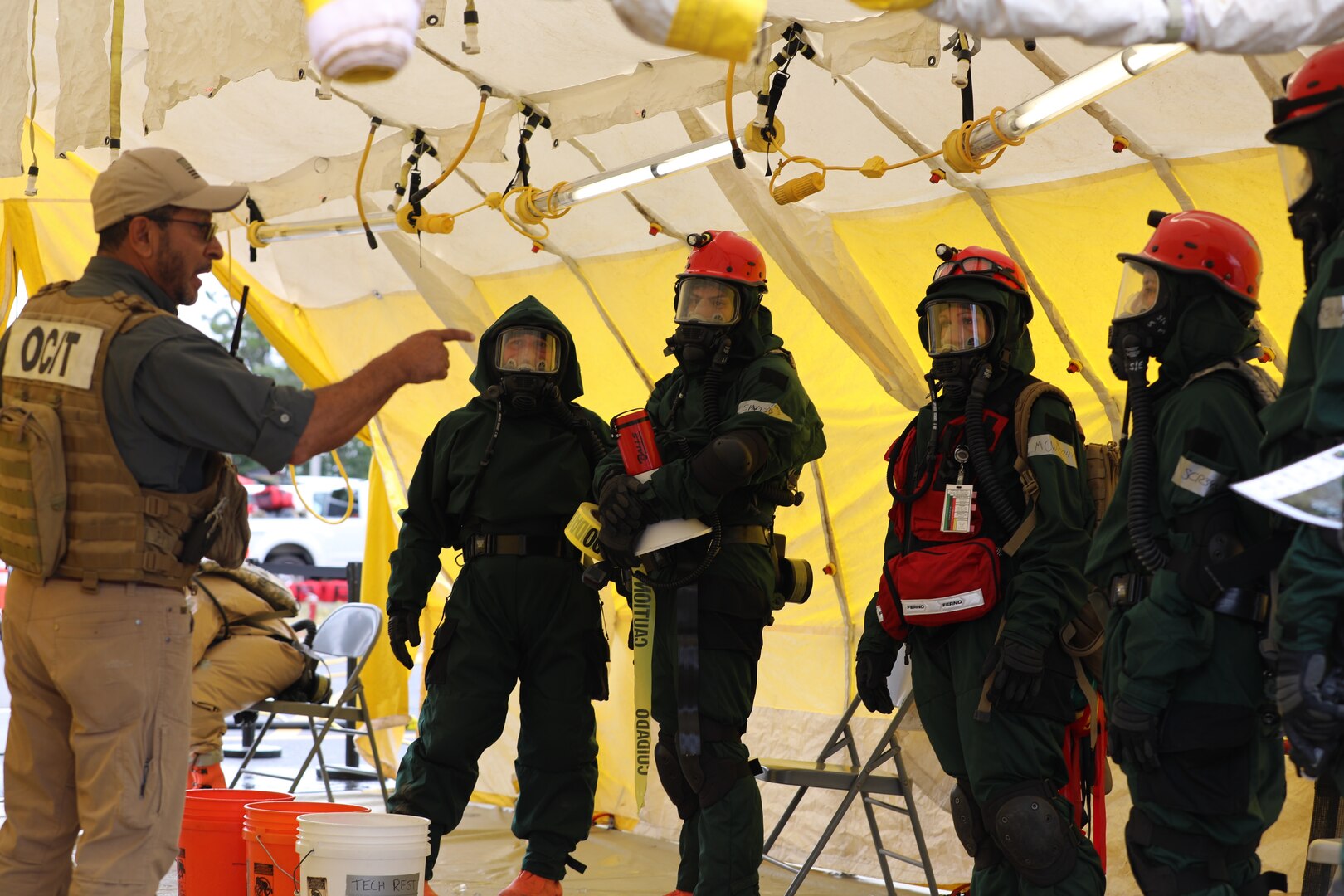A search and extraction team conducts a debriefing with an instructor following their casualty search. Approximately 180 Soldiers and Airmen from Maine, Rhode Island, and New Hampshire came together at Joint Base Cap Cod, Massachusetts, Aug. 12-18, 2023, for an external evaluation of the New England CERFP, a regional National Guard response team that assists first responders during large-scale emergencies.