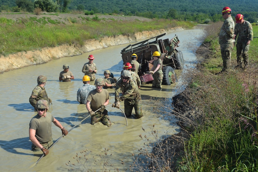 Soldiers attending the towing and recovery specialist course at the U.S. Army Reserve’s Regional Training Site – Maintenance at Fort Indiantown Gap conduct vehicle recovery training at FTIG’s mire pit on Aug. 22, 2023. The class included active-duty, Army Reserve and National Guard Soldiers. (Pennsylvania National Guard photo by Brad Rhen)