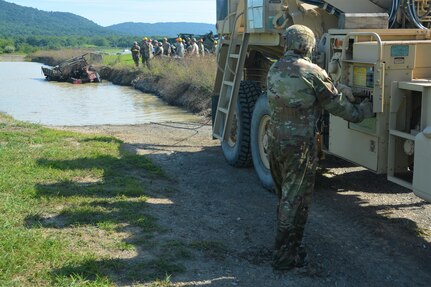 Soldiers attending the towing and recovery specialist course at the U.S. Army Reserve’s Regional Training Site – Maintenance at Fort Indiantown Gap conduct vehicle recovery training at FTIG’s mire pit on Aug. 22, 2023. The class included active-duty, Army Reserve and National Guard Soldiers. (Pennsylvania National Guard photo by Brad Rhen)