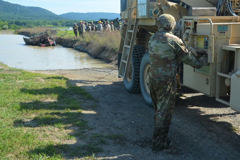 Soldiers attending the towing and recovery specialist course at the U.S. Army Reserve’s Regional Training Site – Maintenance at Fort Indiantown Gap conduct vehicle recovery training at FTIG’s mire pit on Aug. 22, 2023. The class included active-duty, Army Reserve and National Guard Soldiers. (Pennsylvania National Guard photo by Brad Rhen)