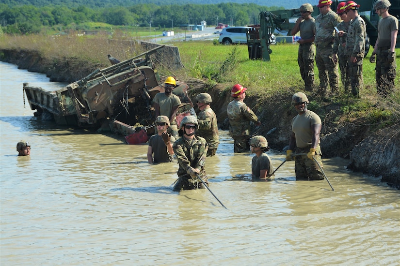 Soldiers attending the towing and recovery specialist course at the U.S. Army Reserve’s Regional Training Site – Maintenance at Fort Indiantown Gap conduct vehicle recovery training at FTIG’s mire pit on Aug. 22, 2023. The class included active-duty, Army Reserve and National Guard Soldiers. (Pennsylvania National Guard photo by Brad Rhen)