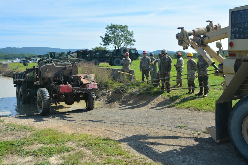 Soldiers attending the towing and recovery specialist course at the U.S. Army Reserve’s Regional Training Site – Maintenance at Fort Indiantown Gap conduct vehicle recovery training at FTIG’s mire pit on Aug. 22, 2023. The class included active-duty, Army Reserve and National Guard Soldiers. (Pennsylvania National Guard photo by Brad Rhen)