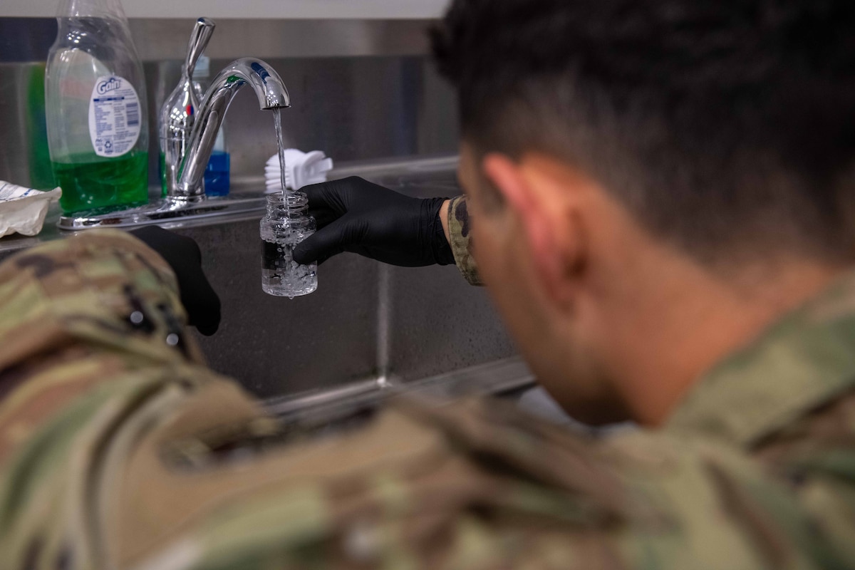 Airman 1st Class Daniel Matar, 22nd Operational Medical Readiness Squadron bioenvironmental engineering technician, takes a 100ml bacteriological sample of water to test for contaminants and bacteria August 23, 2023, at McConnell Air Force Base, Kansas. After a Boil Water Advisory on base, bioenvironmental engineering initiated a comprehensive water quality testing program to ensure the water met safety standards. (U.S. Air Force photo by Staff Sgt. Adam Goodly)