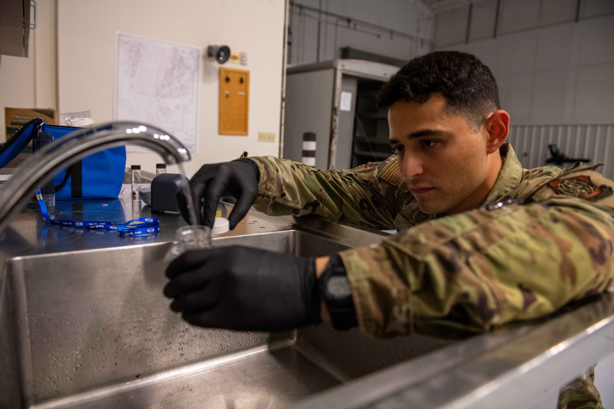 Airman 1st Class Daniel Matar, 22nd Operational Medical Readiness Squadron bioenvironmental engineering technician, takes a 100ml bacteriological sample of water to test for contaminants and bacteria August 23, 2023, at McConnell Air Force Base, Kansas. After a Boil Water Advisory on base, bioenvironmental engineering initiated a comprehensive water quality testing program to ensure the water met safety standards. (U.S. Air Force photo by Staff Sgt. Adam Goodly)