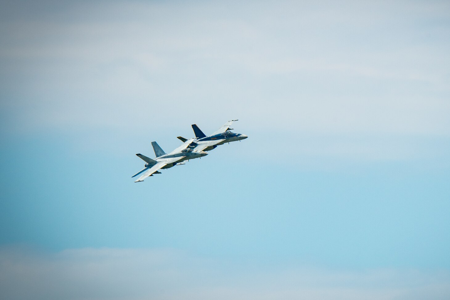 Two jets fly during an Airborne Change of Command