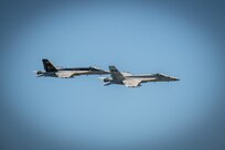 Two jets fly during a Airborne Change of Command