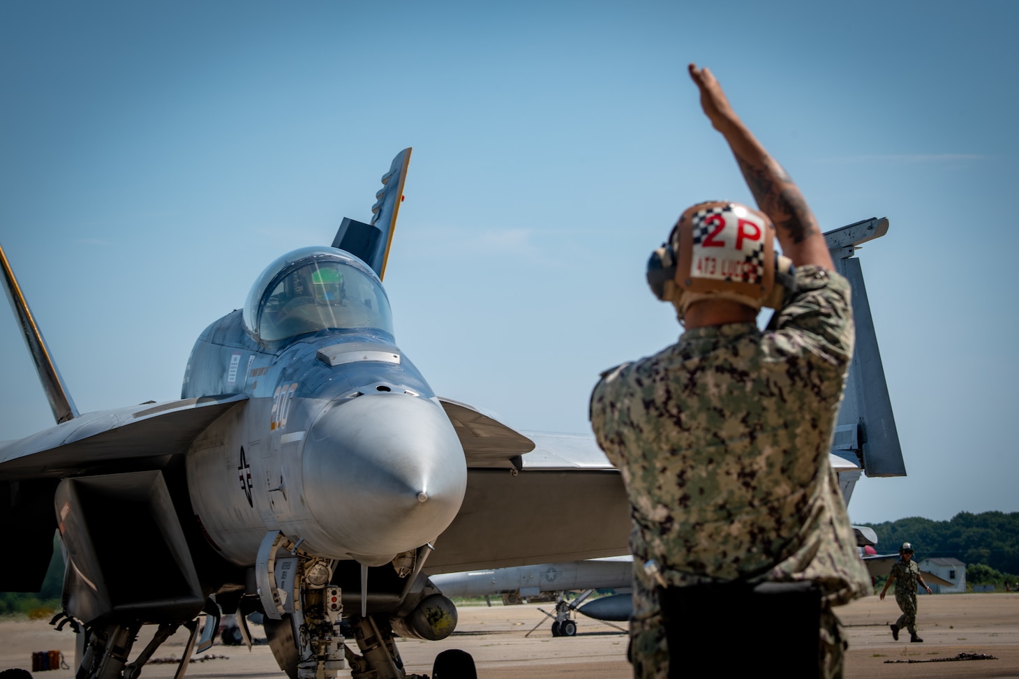 Sailor directs jet on flightline