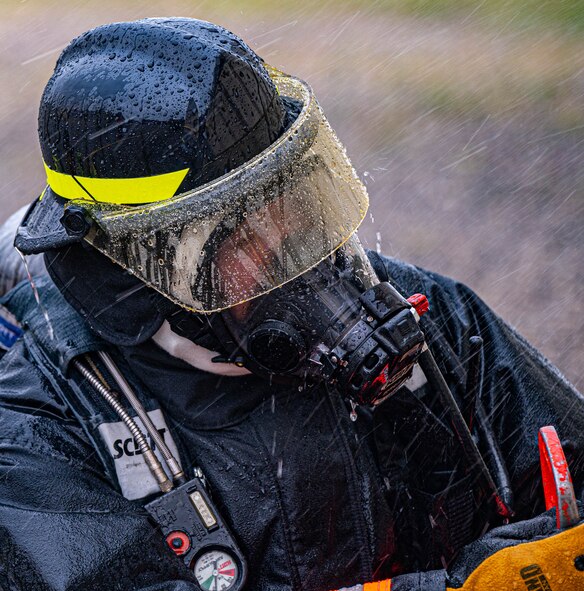 A member of the city of Glenburn volunteer fire department works to extinguish an ongoing fire during a live structure fire exercise at Minot Air Force Base, North Dakota, Aug. 21, 2023. Minot Air Force base fire protection specialists don’t just act on Air Force bases, but assist civilian fire departments when needed as well. (U.S. Air Force photo by Airman 1st Class Alexander Nottingham)