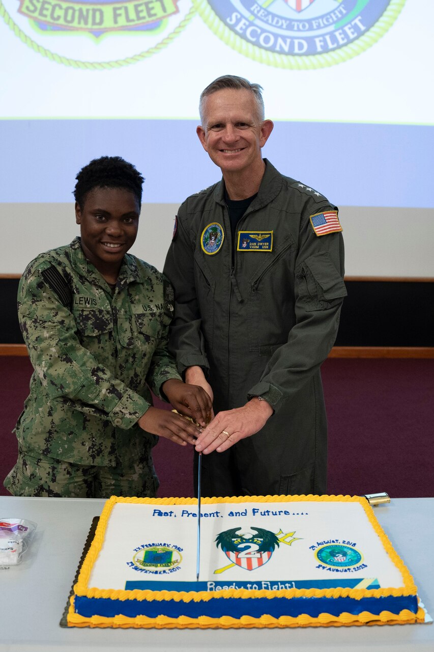 NORFOLK, Va. - Vice Adm. Daniel Dwyer, commander, U.S. 2nd Fleet, poses for a cake-cutting photo with Culinary Specialist Seaman Apprentice Samarian Lewis during a five-year anniversary celebration for U.S. 2nd Fleet. U.S. 2nd Fleet employs maritime forces ready to fight across multiple domains in the Atlantic and Arctic in order to ensure access, deter aggression and defend U.S., allied, and partner interests. (U.S. Navy photo by Mass Communication Specialist 2nd Class Anderson W. Branch)