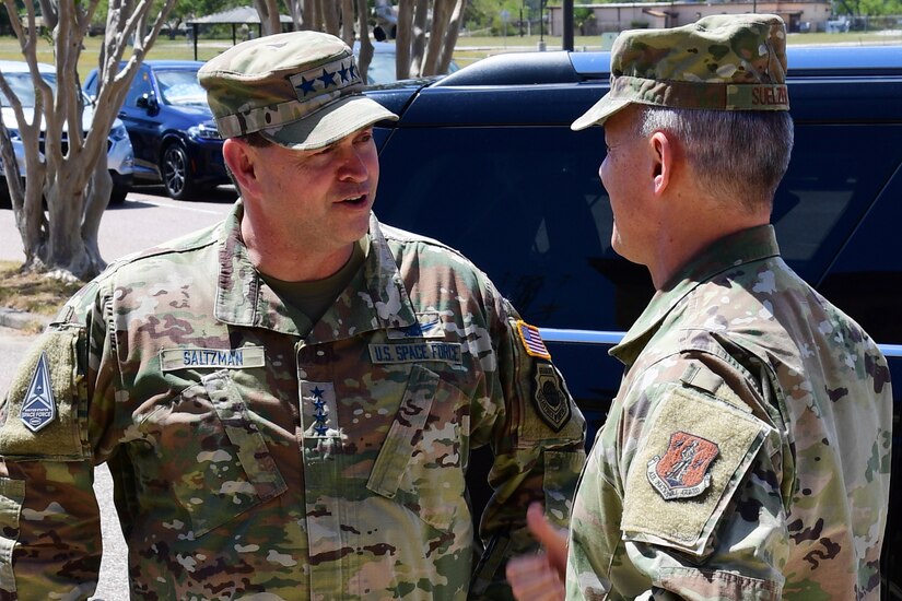 Two military officers speak to each other.