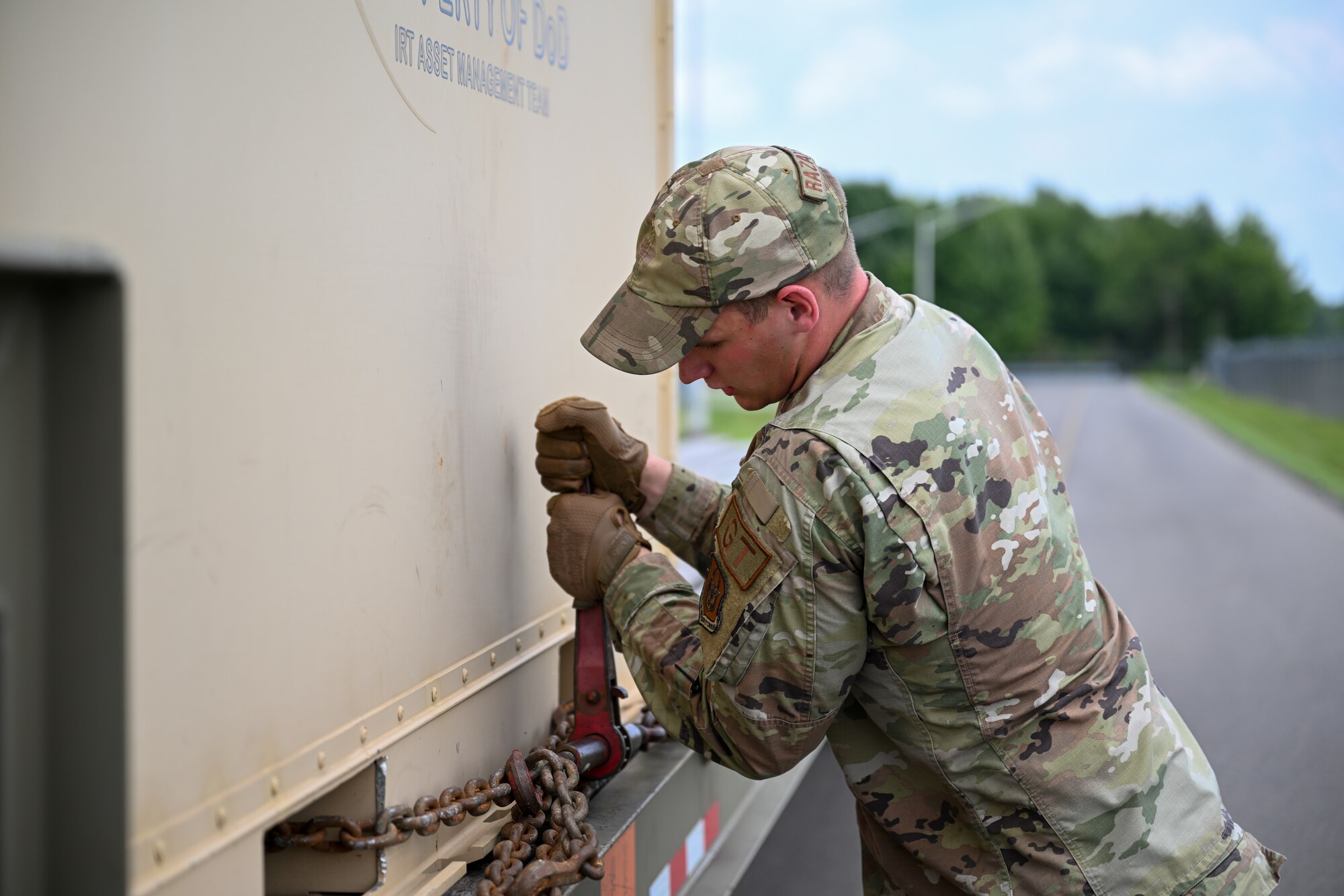 U.S. Air Force Senior Airman Aaron Razayeski, a Consolidated Asset Management Site ground transport specialist for the Innovative Readiness Training program, secures a medical equipment container onto a tractor-trailer, July 28, 2023, at Youngstown Air Reserve Station, Ohio.