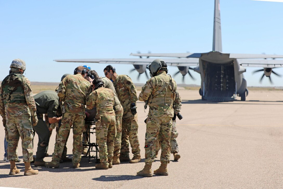 U.S. Army Reserve critical care flight paramedics from 5-159th General Support Aviation Battalion, 244th Expeditionary Combat Aviation Brigade, Army Reserve Aviation Command, work alongside Air Force Reserve medical personnel from the 302nd Airlift Wing to transfer a casualty from an Army Reserve HH-60 MEDEVAC Black Hawk to an Air Force C-130 in a Tail to Tail training scenario during exercise Mountain Medic at Fort Carson, Colorado, Aug. 15, 2023. Mountain Medic is an Army Reserve-led joint, multi-component, multi-domain aeromedical evacuation exercise geared at improving and reenforcing medical evacuation operations in a simulated large scale combat operations environment.