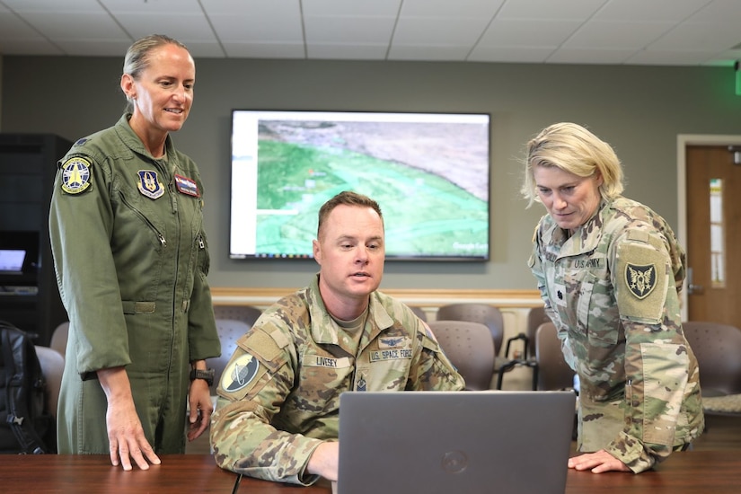 (Left to right) Air Force Lt. Col. Kristina Spindel, chief nurse of the 34th Aeromedical Evacuation Squadron, Space Force Master Sgt. Michael Livesey, intelligence noncommissioned officer for 12th Delta Operations Squadron, and Army Reserve Lt. Col. Jennifer Housholder, Army Reserve Aviation Command training officer and Mountain Medic officer-in-charge, discuss daily planning and operations during exercise Mountain Medic at Fort Carson, Colorado, Aug. 16, 2023. Mountain Medic is an Army Reserve-led joint, multi-component, multi-domain aeromedical evacuation exercise geared at improving and reenforcing medical evacuation operations in a simulated large scale combat operations environment.