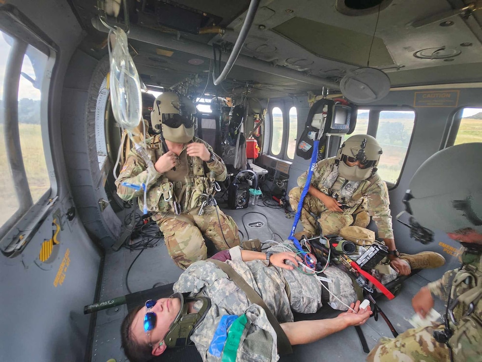 U.S. Army Reserve critical care flight paramedics from 5-159th General Support Aviation Battalion, 244th Expeditionary Combat Aviation Brigade, Army Reserve Aviation Command, treat a casualty in a HH-60 MEDEVAC Black Hawk during exercise Mountain Medic at Fort Carson, Colorado, Aug. 14, 2023. Mountain Medic is an Army Reserve-led joint, multi-component, multi-domain aeromedical evacuation exercise geared at improving and reenforcing medical evacuation operations in a simulated large scale combat operations environment.