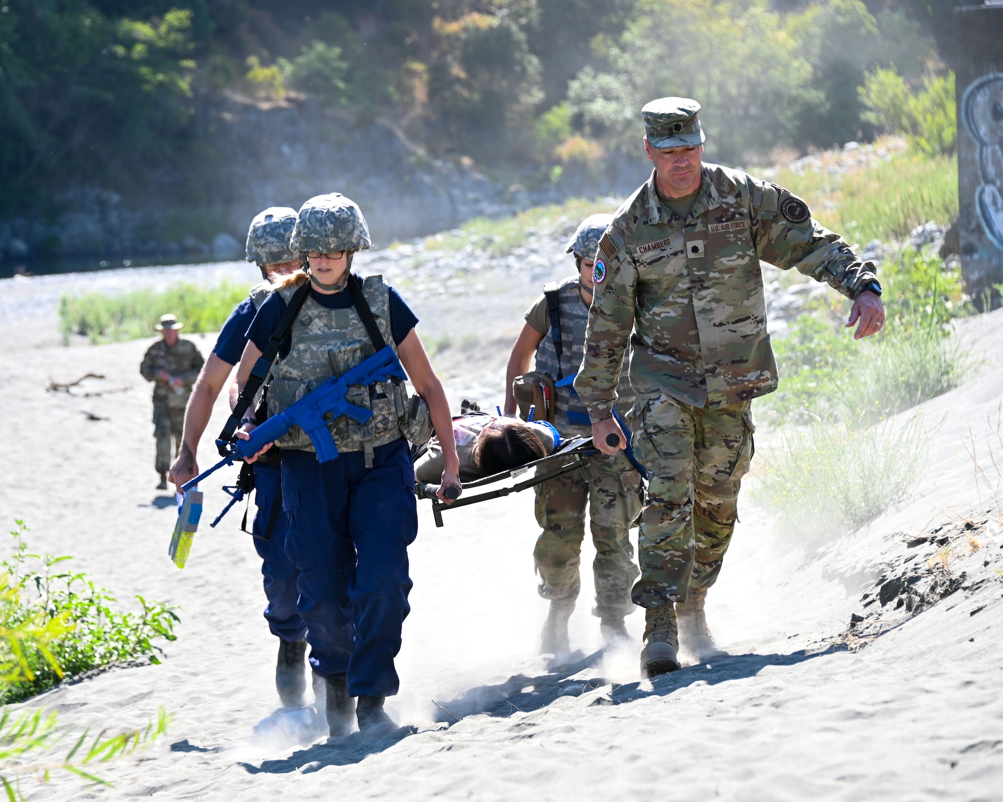 U.S. Air Force Public Health Service and Air National Guardsmen carry injured personnel during Operation Hoopa Health Services August 1-13, 2023.