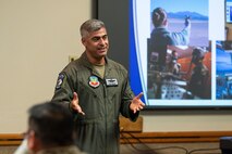 U.S. Air Force Lt. Col. Ruben Amezaga, the 57th Operational Support Squadron chief of safety, delivers remarks during an honorary commander induction ceremony at Nellis Air Force Base, Nevada, Aug 18, 2023. The honorary commander program helps community leaders gain a deeper understanding of operations and the vital role the base plays in national defense. (U.S. Air Force photo by Airman 1st Class Jordan McCoy)