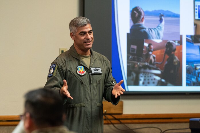 U.S. Air Force Lt. Col. Ruben Amezaga, the 57th Operational Support Squadron chief of safety, delivers remarks during an honorary commander induction ceremony at Nellis Air Force Base, Nevada, Aug 18, 2023. The honorary commander program helps community leaders gain a deeper understanding of operations and the vital role the base plays in national defense. (U.S. Air Force photo by Airman 1st Class Jordan McCoy)