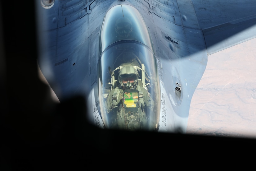 A fighter jet receives fuel while in flight.