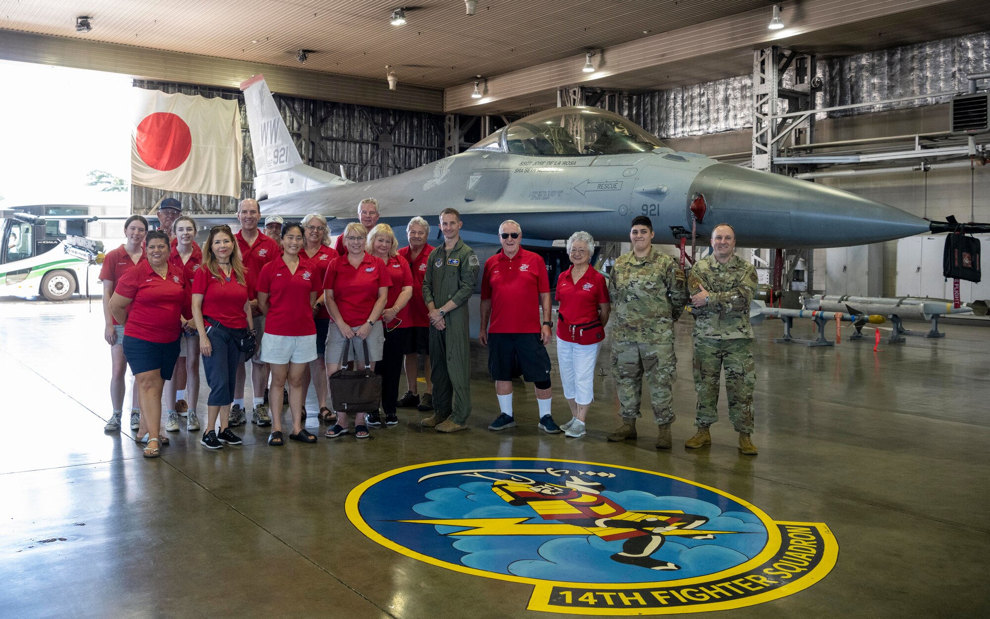 Sister city delegates pose with 35th Fighter Wing leadership in front of an F-16