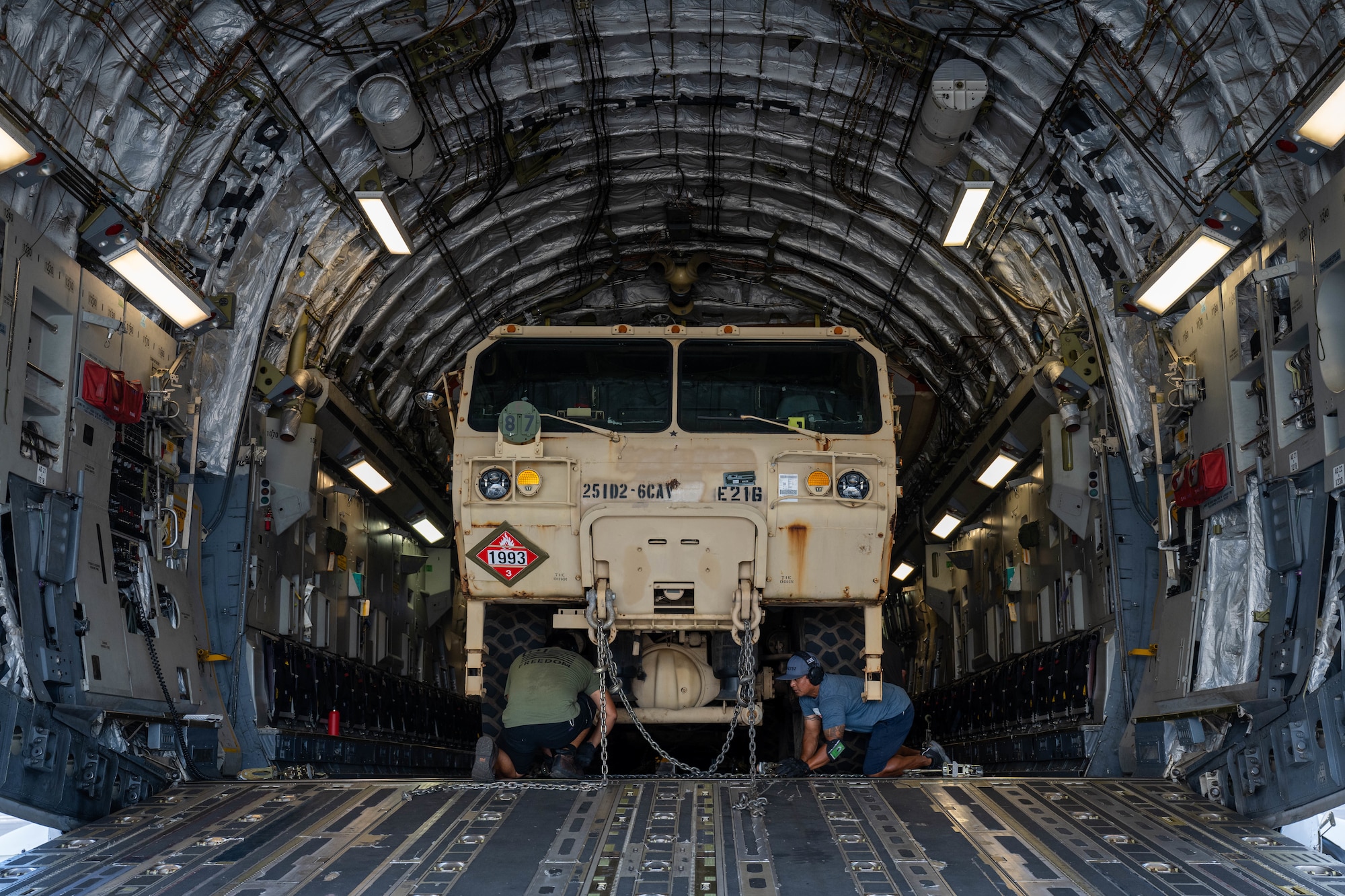 Members from the 735th Air Mobility Squadron secure a Heavy Expanded Mobility Tactical Truck on a C-17 Globemaster III in support of a Maui wildfire humanitarian aid and disaster relief flight on the island of Maui at Joint Base Pearl Harbor-Hickam, Hawaii, August 19, 2023. Airmen from the 535th Airlift Squadron and 735th AMS transported equipment and resources to Joint Task Force 50 to help the communities affected by the wildfires in Maui. (U.S. Air Force photo by Senior Airman Makensie Cooper)