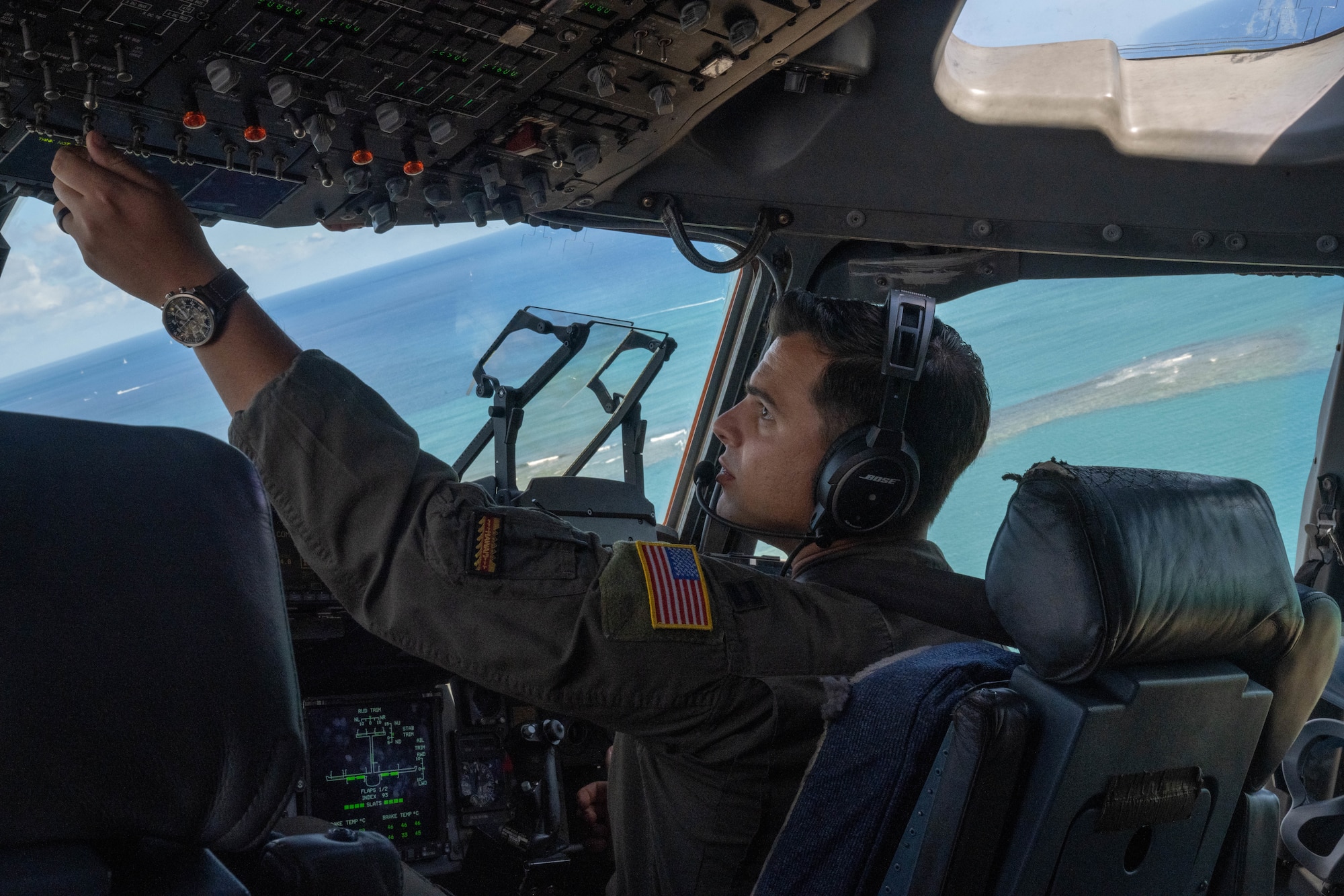 U.S. Air Force Capt. Logan Hawke, 535th Airlift Squadron pilot, flies a C-17 Globemaster III during a humanitarian aid and disaster relief flight in support of Maui wildfire recovery around the Islands of Hawaii, August 19, 2023. Members from the 535th AS transported U.S. Soldiers to the island of Maui to help those impacted by the wildfires and to provide aid and disaster relief to the impacted communities. (U.S. Air Force photo by Senior Airman Makensie Cooper)