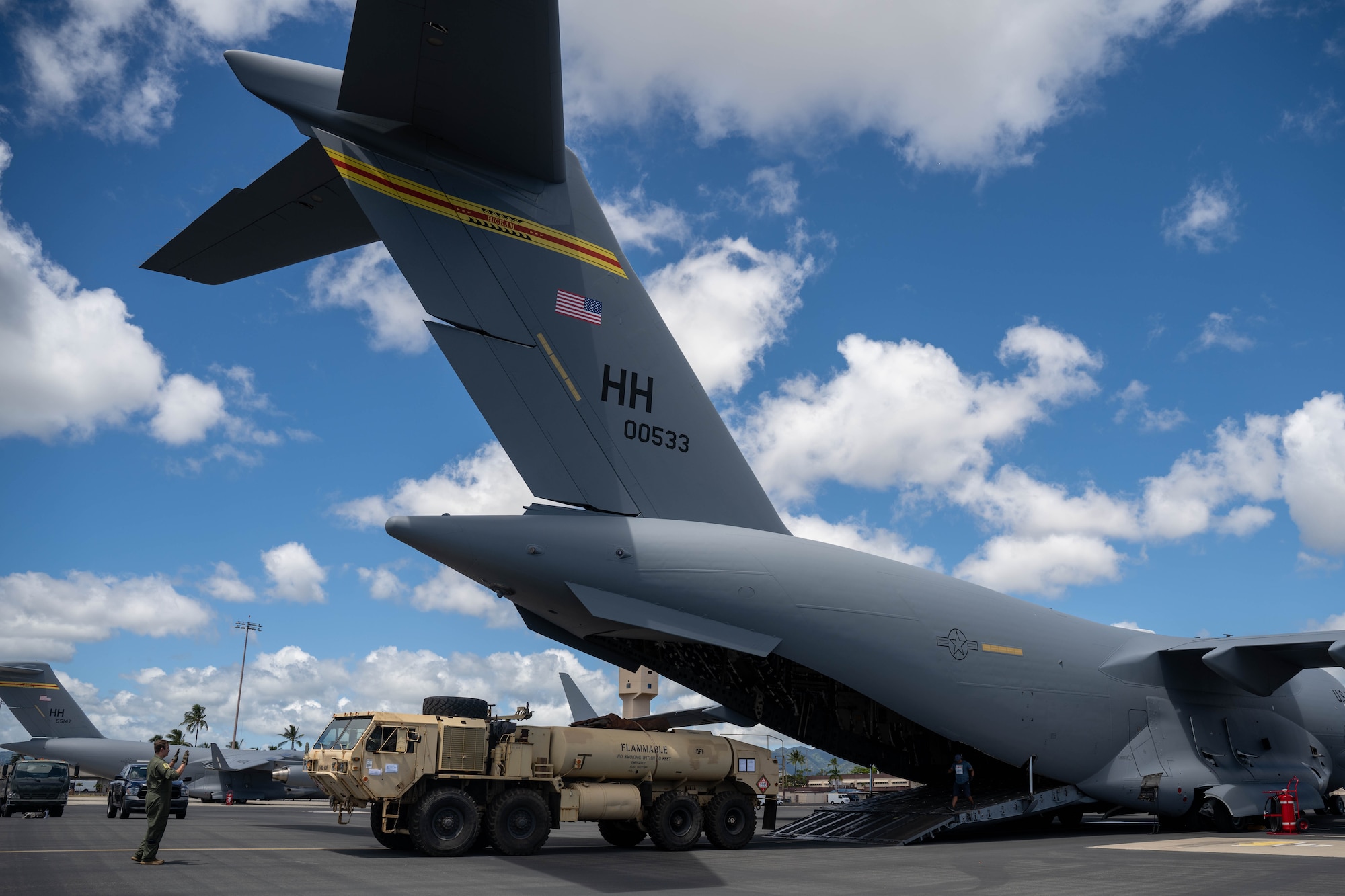 Airmen assigned to the 535th Airlift Squadron load cargo onto a C-17 Globemaster III in support of Maui wildfire recovery at Joint Base Pearl Harbor-Hickam, Hawaii, August 19, 2023. Airmen and Soldiers from the 535th AS and 524th Division Sustainment Support Battalion delivered equipment and resources to Joint Task Force 50 to help the communities affected by the wildfires in Maui. (U.S. Air Force photo by Senior Airman Makensie Cooper)