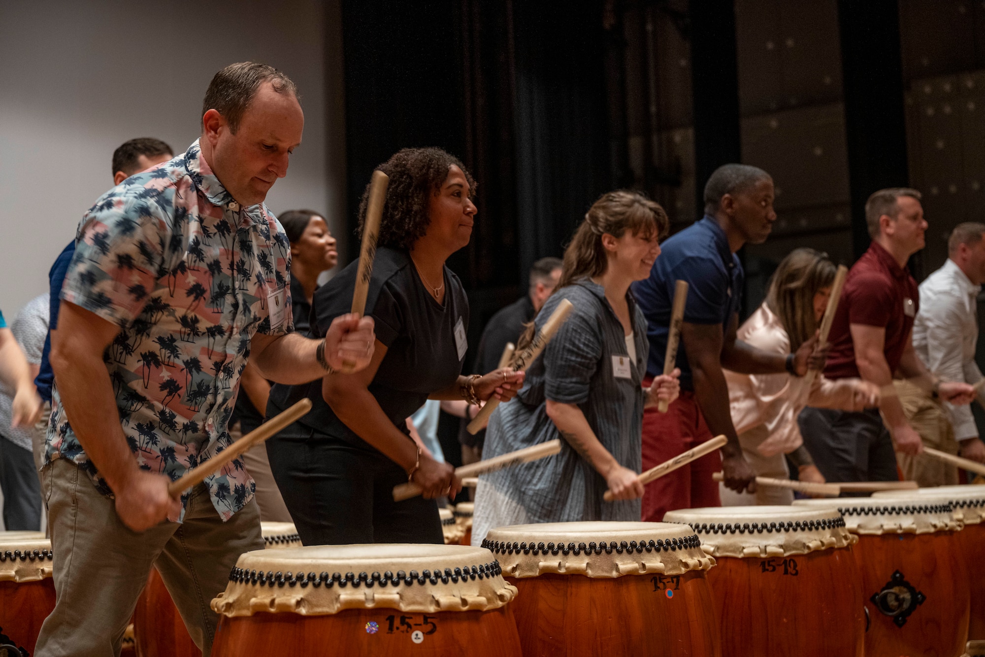 Commanders and senior enlisted leaders assigned to the 35th Fighter Wing play traditional Japanese taiko drums during a team building event at the Misawa International Center.