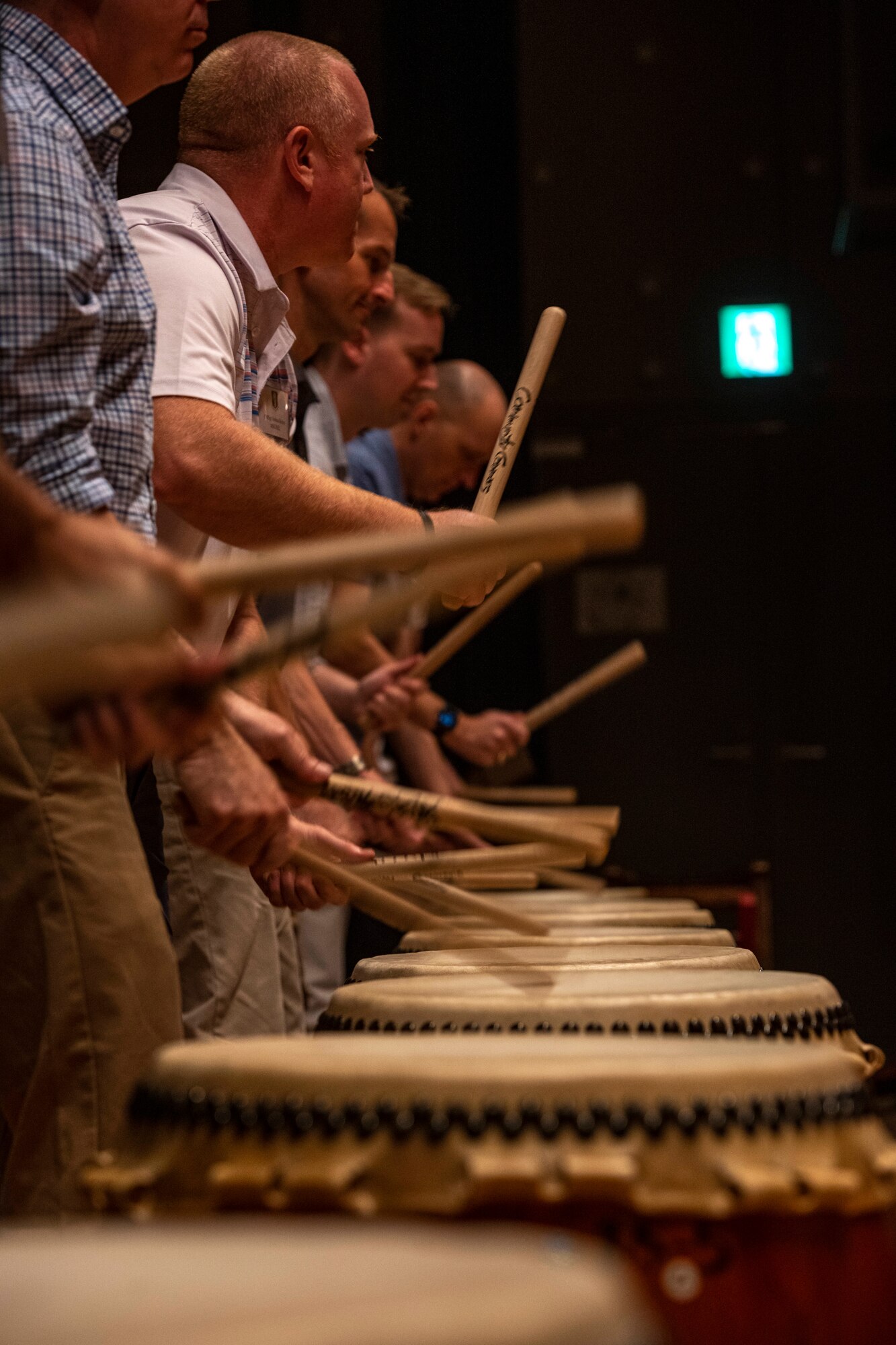 Commanders and senior enlisted leaders assigned to the 35th Fighter Wing play traditional Japanese taiko drums during a team building event at the Misawa International Center