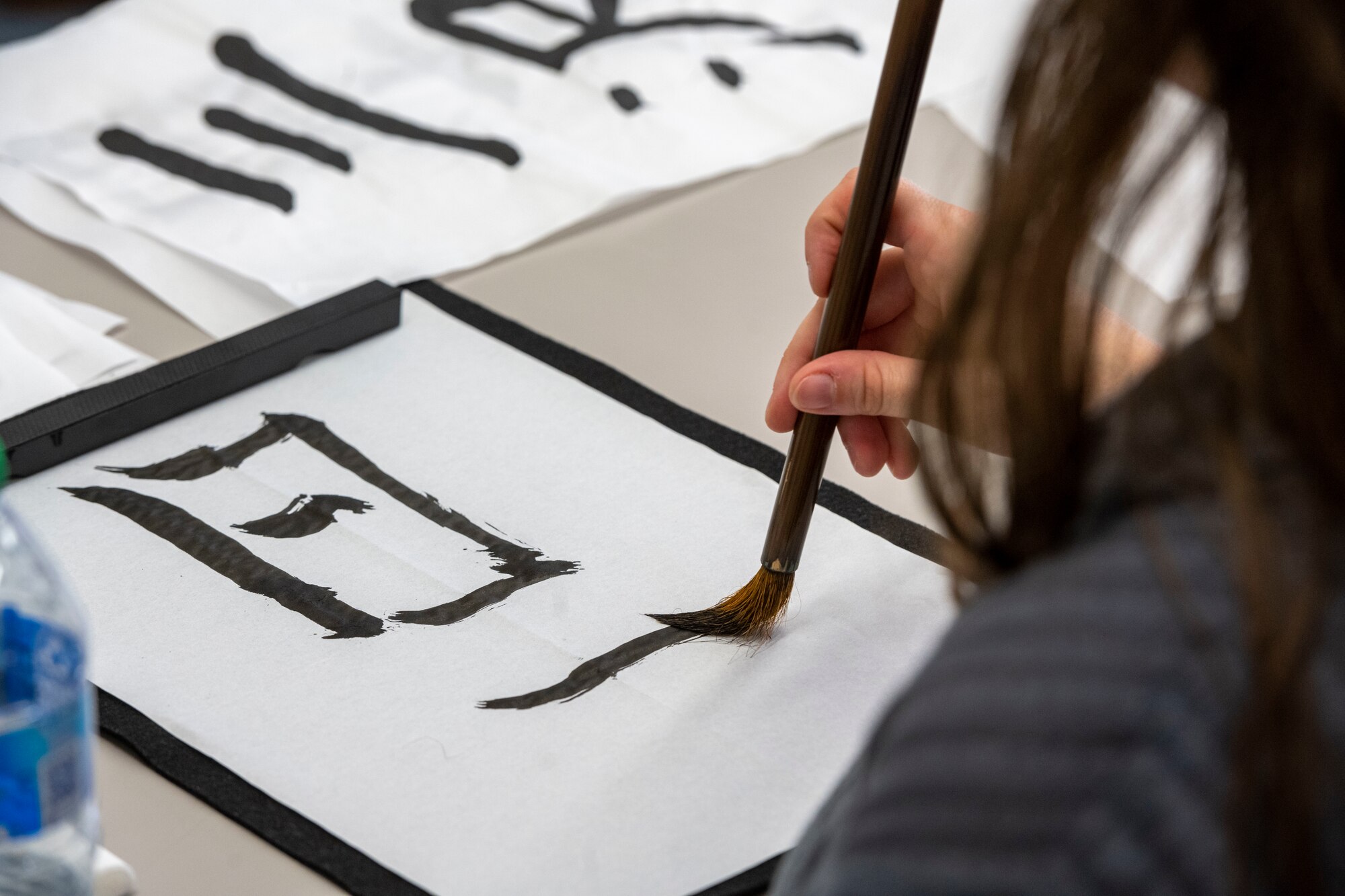 A member of Team Misawa practices calligraphy during a team building event at the Misawa International Center.