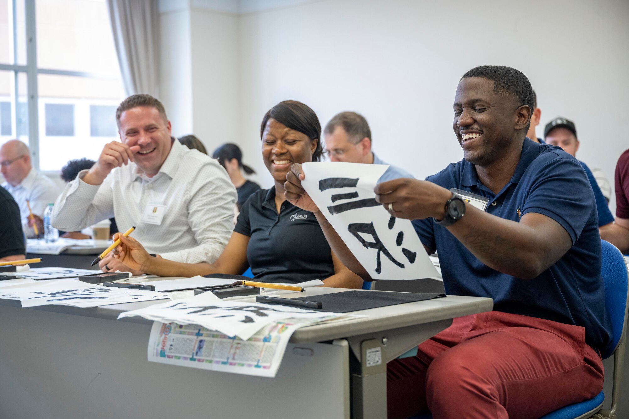 35th Fighter Wing senior enlisted leaders practice calligraphy during a team building event held at the Misawa International Center.