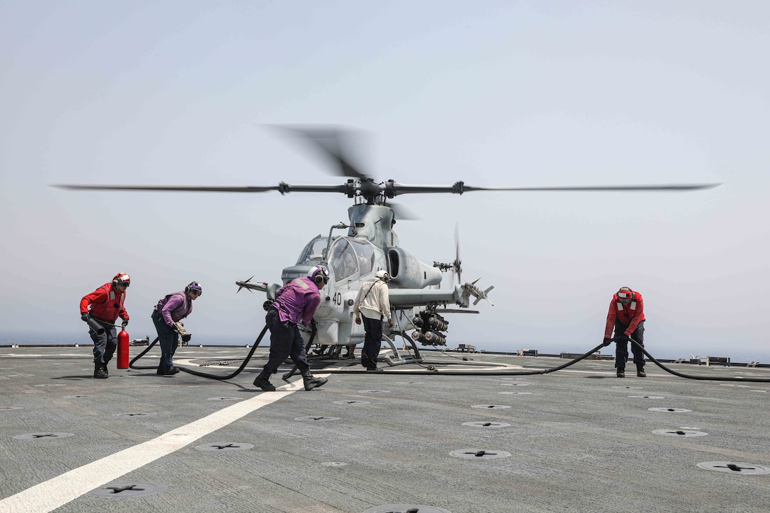 230814-N-ED646-2036- GULF OF OMAN (Aug. 14, 2023) Sailors assigned to dock landing ship USS Carter Hall (LSD 50) refuel a U.S. Marine Corps AH-12 Viper helicopter, attached to Marine Medium Tiltrotor Squadron 162, 26th Marine Expeditonary Unit (MEU), during flight operations in the Gulf of Oman, Aug. 14, 2023. Components of the Bataan Amphibious Ready Group and 26th Marine Expeditionary Unit are deployed to the U.S. 5th Fleet area of operations to help ensure maritime security and stability in the Middle East Region. (U.S. Navy photo by Mass Communication Specialist 2nd Class Moises Sandoval)