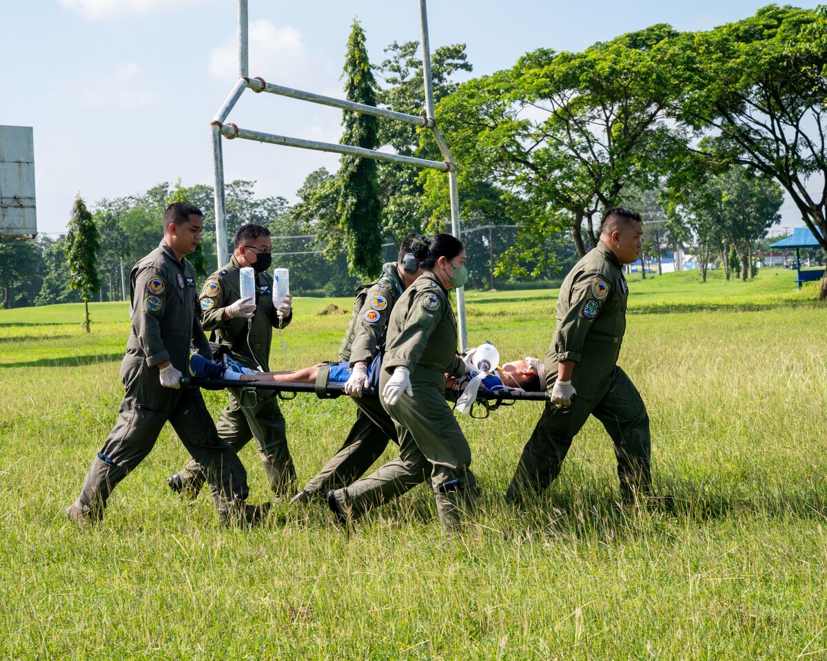 Philippine Air Force medics carry a simulated post-disaster priority care patient to the rescue helicopter to prepare for rapid airlift transportation during Pacific Airlift Rally 2023 at Clark Air Base, Philippines, Aug. 16, 2023. Training, education, and exchange programs between the U.S. Air and Space forces and their global partners provide mutually beneficial learning opportunities and promote long-term partnerships between international military leaders and servicemembers. (U.S. Air Force photo by Senior Airman Jordan Smith)
