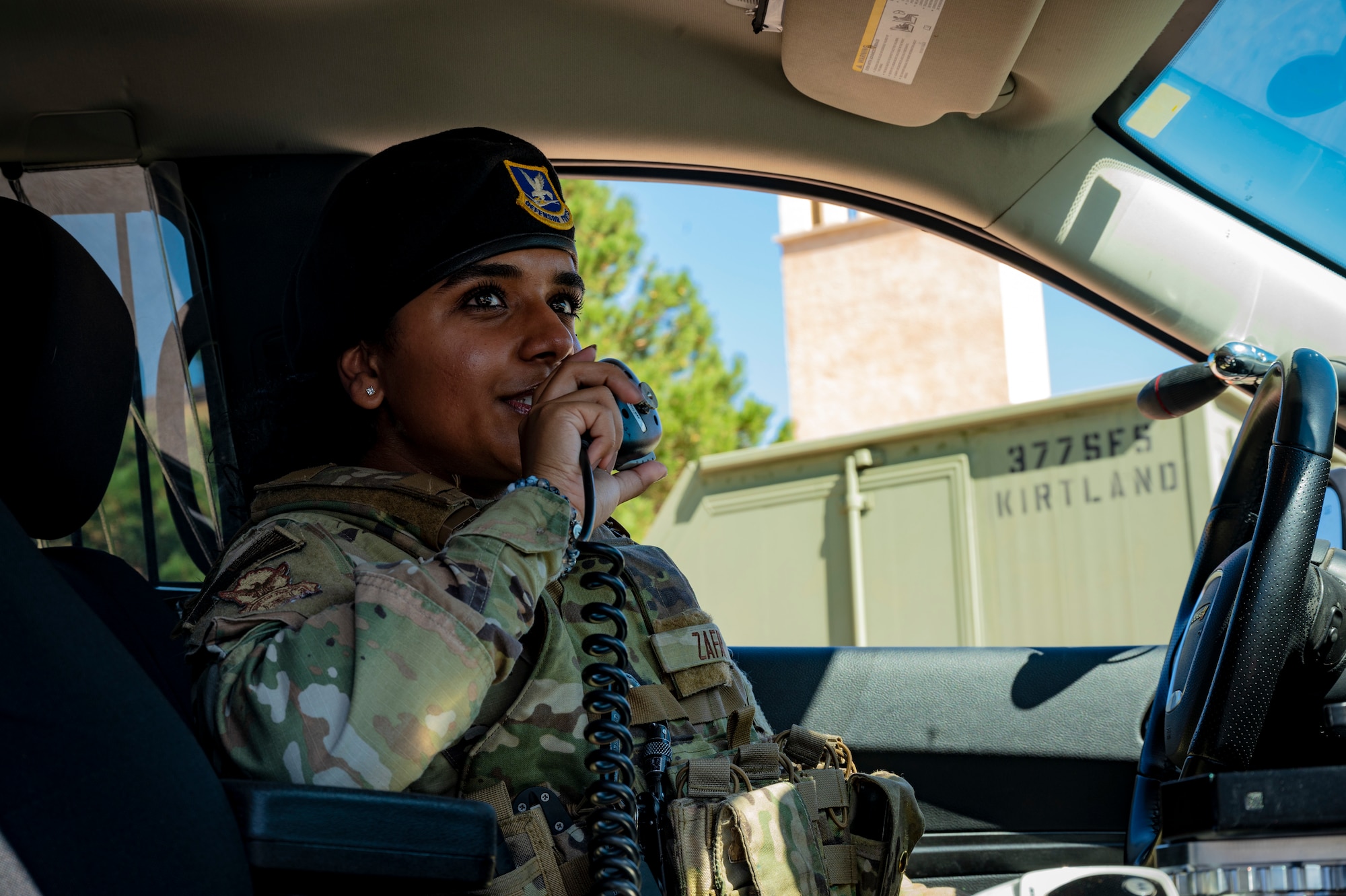 A woman speaks into a radio.