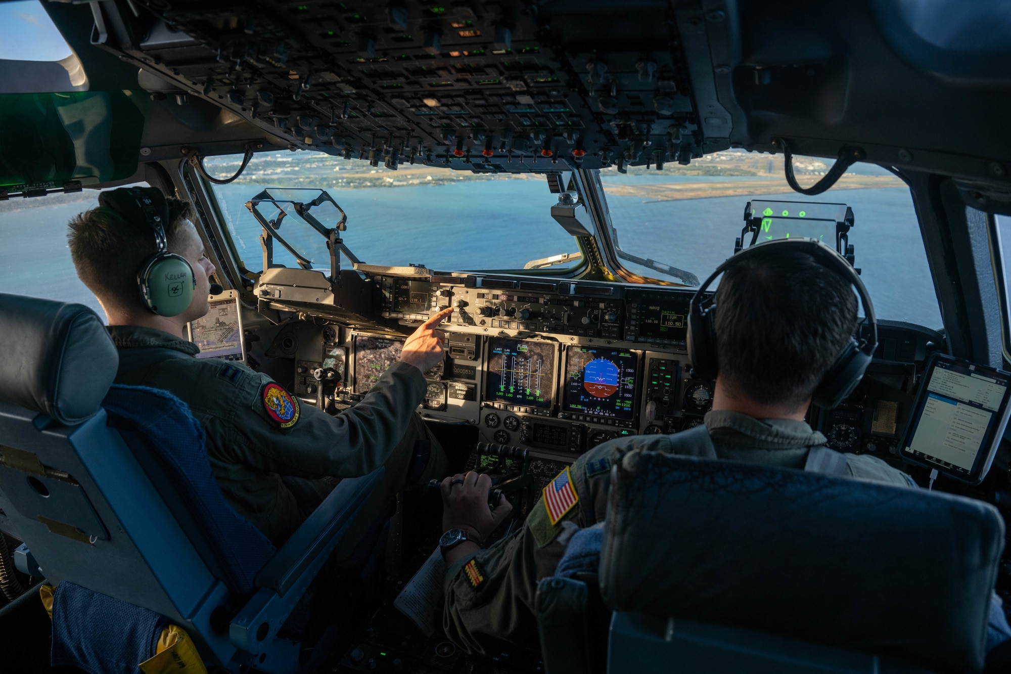 U.S. Air Force Capt. Alex Keller and Capt. Logan Hawke, 535th Airlift Squadron pilots, fly a C-17 Globemaster III during a humanitarian and disaster relief flight in support of Maui wildfire recovery around the Islands of Hawaii, August 19, 2023. Members from the 535th AS transported personnel and equipment from the U.S. Army in support of Joint Task Force 50 to provide humanitarian aid and assistance and offer continued support to the communities impacted by the wildfires. (U.S. Air Force photo by Senior Airman Makensie Cooper)