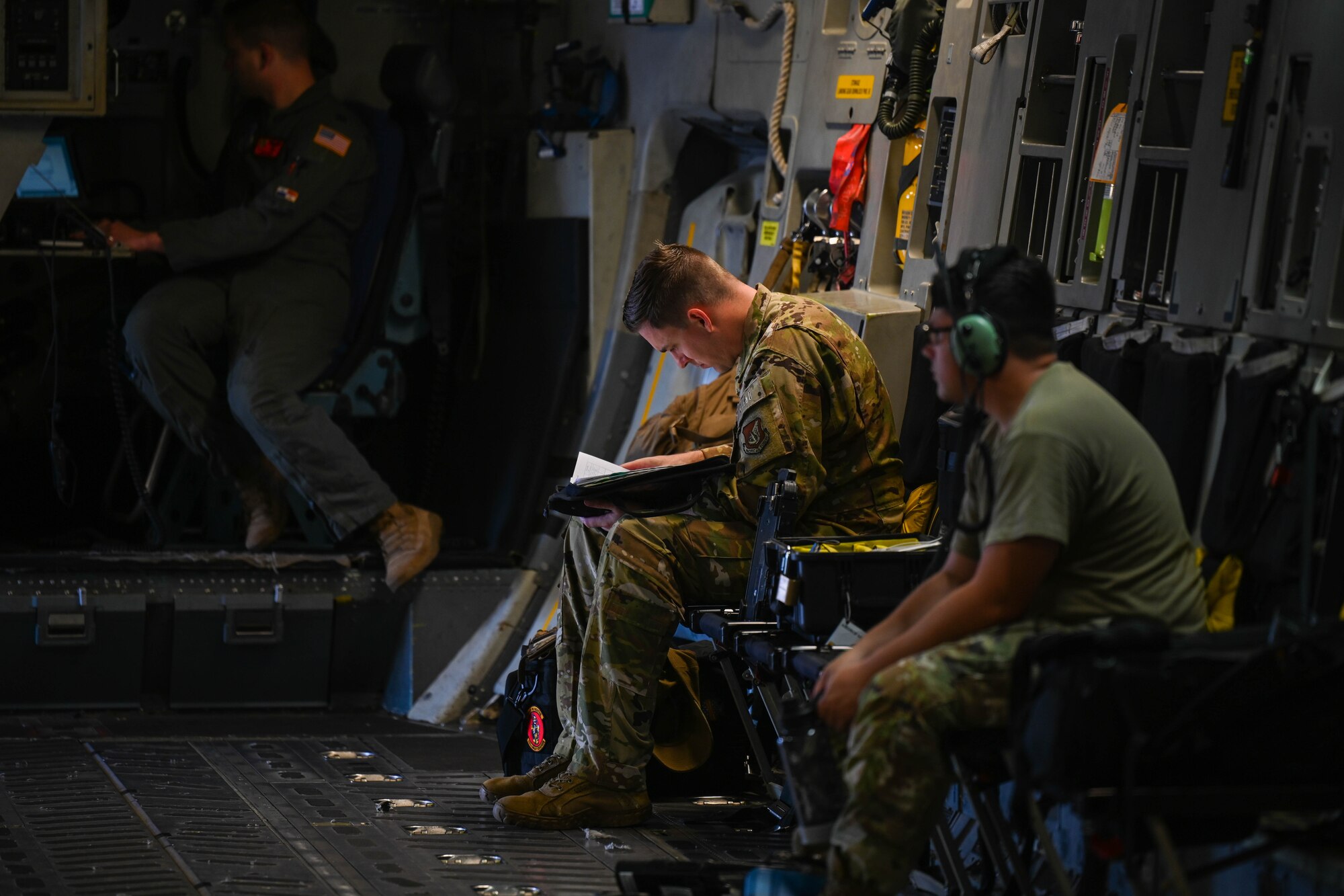 U.S. Air Force Technical Sgt. Drew Gayhart, 535th Airlift Squadron loadmaster, performs his preflight checklist before a humanitarian aid and disaster relief flight to the Island of Maui at Joint Base Pearl Harbor-Hickam, Hawaii, August 19, 2023. Airmen from the 535th AS and 735th Air Mobility Squadron transported equipment and resources to Joint Task Force 50 to help the communities affected by the wildfires in Maui. (U.S. Air Force photo by Senior Airman Makensie Cooper)