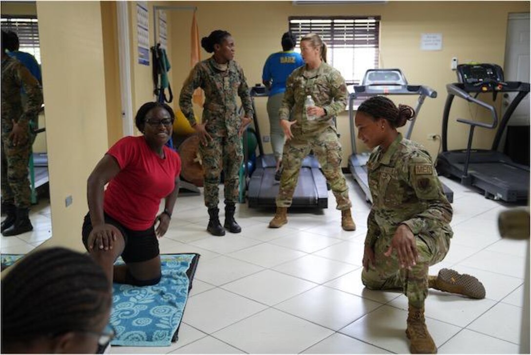 Senior Airman Oshin Mullings, a physical therapy technician with the 633rd Operational Medical Readiness Squadron at Langley Air Force Base, Va., demonstrates physical therapy techniques alongside a Jamaican soldier as part of a collaborative healthcare visit at the Jamaica Defense Forces Medical Center in Kingston. This Embedded Health Engagement Team shared best practices to help boost Jamaica’s military medical readiness, strengthening relationships and building trust with this U. S. partner in the Caribbean.