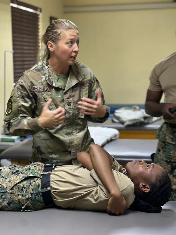 Maj. Joanna Borawski, the IRON Physical Resilience branch chief from the 1st Special Operations Wing at Hurlburt Field, Fla., instructs Jamaican military healthcare teams on physical therapy techniques as part of a collaborative healthcare visit at the Jamaica Defense Forces Medical Center in Kingston. This Embedded Health Engagement Team shared best practices to help boost Jamaica’s military medical readiness, strengthening relationships and building trust with this U. S. partner in the Caribbean.