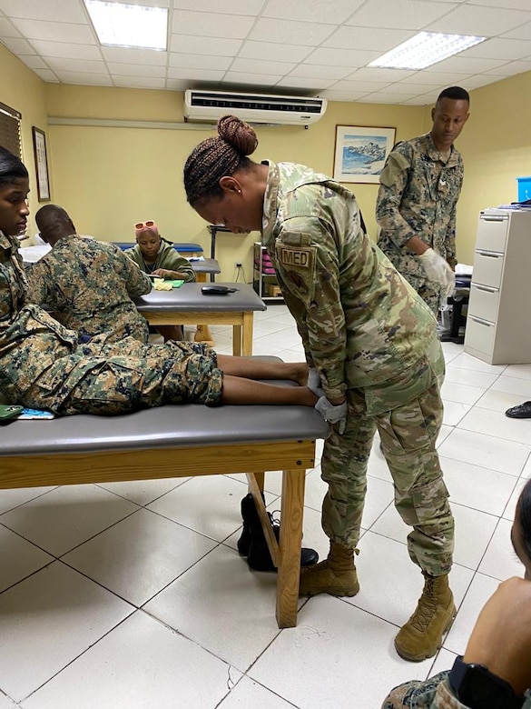 Senior Airman Oshin Mullings, a physical therapy technician with the 633rd Operational Medical Readiness Squadron at Langley Air Force Base, Va., treats a Jamaican soldier as part of a collaborative healthcare visit at the Jamaica Defense Forces Medical Center in Kingston. This Embedded Health Engagement Team shared best practices to help boost Jamaica’s military medical readiness, strengthening relationships and building trust with this U. S. partner in the Caribbean.