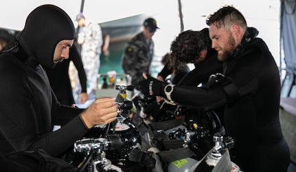 Royal Australian Navy (RAN) Clearance Divers conduct a pre-check on their diving rigs prior to a simulated hull search exercise in Sydney, Australia, during Exercise Malabar 2023, August 15. This iteration of Malabar is the first year with Australia as the host country. Malabar 23 is a surface, air, and subsurface multilateral field training exercise conducted with RAN, Indian Navy, Japan Maritime Self-Defense Force, and U.S. Navy that enhances interoperability and strengthens ties and critical partnerships between the maritime forces and demonstrates the countries commitment to the Indo-Pacific region.