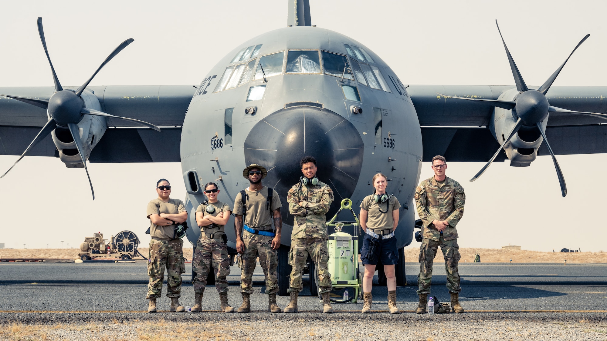 Airmen from the 386th Expeditionary Aircraft Maintenance Squadron and the 386th Expeditionary Logistics Readiness Squadron pose for a photo before a training event at Ali Al Salem Air Base, Kuwait, Aug. 22, 2023. Airmen from both squadrons trained each other and swapped roles for this event to ensure everyone remains multi-capable and ready to lend a hand in generating airpower wherever they are needed. (U.S. Air Force photo by Staff Sgt. Kevin Long)