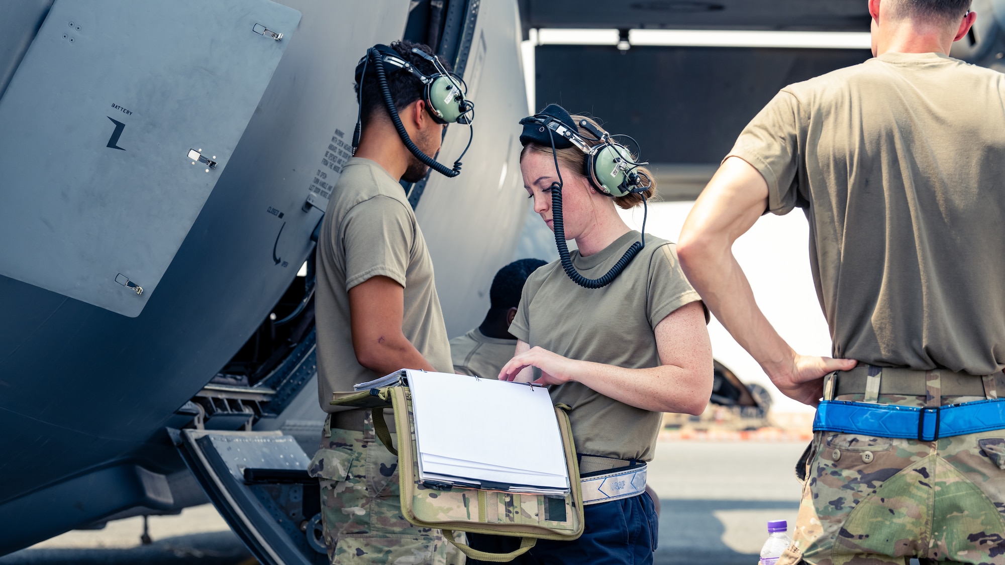 Senior Airman Megan Saylor, 386th Expeditionary Logistics Readiness Squadron passenger services representative, reviews a checklist during a training event with the 386th Expeditionary Aircraft Maintenance Squadron at Ali Al Salem Air Base, Kuwait, Aug. 22, 2023. Airmen from both squadrons trained each other and swapped roles for this event to ensure everyone remains multi-capable and ready to lend a hand in generating airpower wherever they are needed. (U.S. Air Force photo by Staff Sgt. Kevin Long)