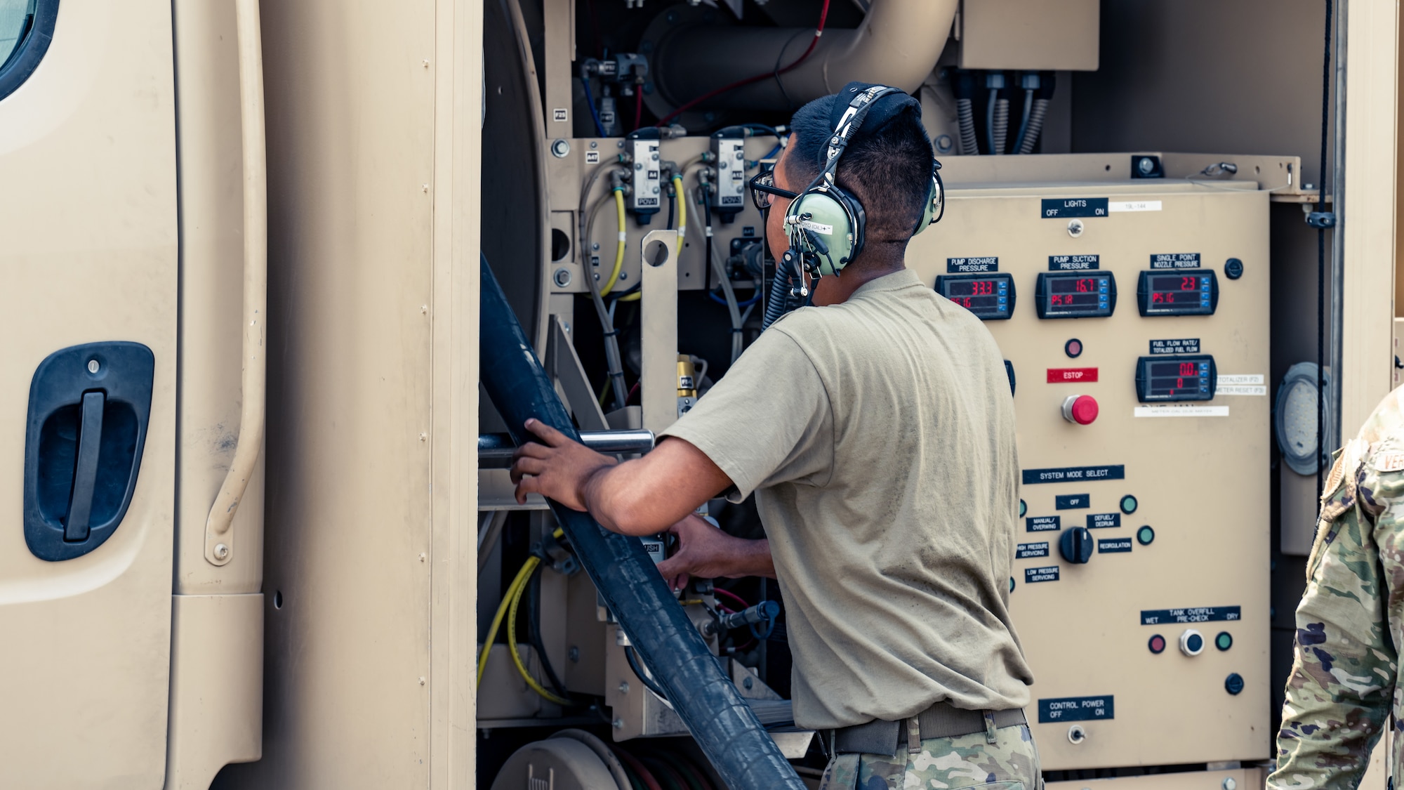 An Airman assigned to the 386th Expeditionary Aircraft Maintenance Squadron inspects a fuel hose connection during a training event with the 386th Expeditionary Logistics Readiness Squadron at Ali Al Salem Air Base, Kuwait, Aug. 22, 2023. Airmen from both squadrons trained each other and swapped roles for this event to ensure everyone remains multi-capable and ready to lend a hand in generating airpower wherever they are needed. (U.S. Air Force photo by Staff Sgt. Kevin Long)